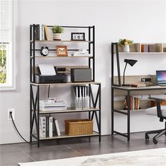 a room with a desk, chair and bookshelf next to a large window