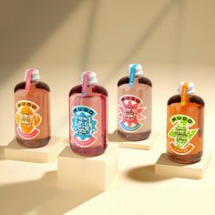 three bottles with toothbrushes in them on display