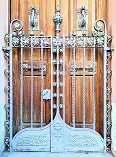 an old iron gate with wooden doors