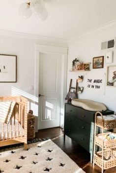 a baby's room with two cribs, a dresser and pictures on the wall