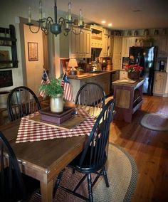 a dining room table with an american flag placemat on it in front of the kitchen