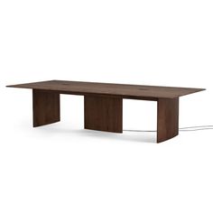 a wooden table with an electrical outlet on the side and one end connected to it