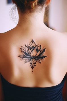 A woman's back with a black and white lotus flower tattoo. Small Feminine Back Tattoos, Interesting Tattoos For Women, Unique Lotus Flower Tattoo, Lotus Tattoos For Women, Lotus Hand Tattoo, Tattoo Ideas For Women Unique, Purple Lotus Tattoo, Lotus Flower Tattoo Ideas, Lotus Tattoo Meaning