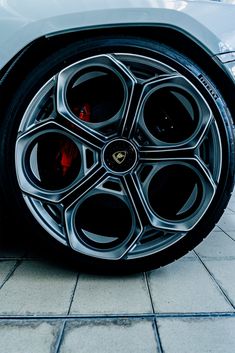 the front wheel of a silver sports car