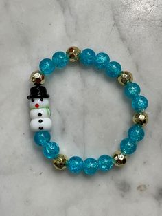 ⛄️kids, are you ready for snow?  This bracelet is for 6 1/2 in wrist.  Makes a great gift for little ones! Cute Turquoise Beaded Bracelets As Gift, Novelty Christmas Jewelry For The Holidays, Novelty Christmas Holiday Jewelry, Christmas Holiday Novelty Jewelry, Fun Blue Bracelets For Gifts, Fun Blue Beaded Bracelets For Gifts, Festive Adjustable Personalized Bracelets, Adjustable Christmas Bracelets For Festive Occasions, Adjustable Christmas Bracelets