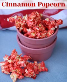 a purple bowl filled with red and white popcorn sitting on top of a blue table