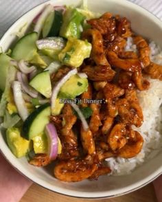 a white bowl filled with rice, meat and veggies on top of it