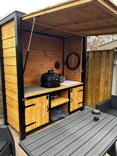 an outdoor kitchen made out of wood and metal