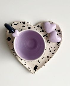 a heart shaped bowl with two hearts on it