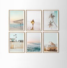 four framed photographs hang on the wall above a table with a surfboard, van and palm trees