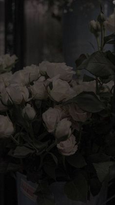 white flowers are in a vase on the table