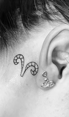 an ear tattoo with the letter s on it's left side behind the ear