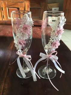 two wine glasses decorated with pink and white flowers