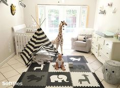 a baby's room with giraffes and zebra rugs on the floor