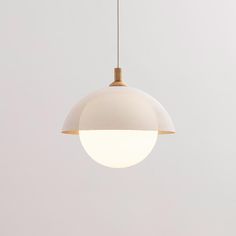 a white and gold light hanging from a ceiling