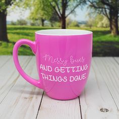 a pink coffee mug with the words messy buns and getting things done written on it