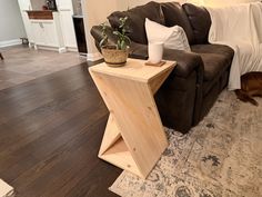 a dog laying on the floor next to a couch and coffee table in a living room