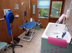 a bathroom with a bathtub, shower head and other items on the counter top