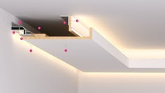 an empty room with white walls and pink dots on the ceiling is lit by recessed lighting