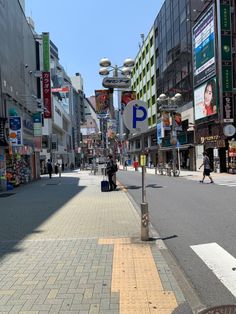 a city street lined with tall buildings and shops