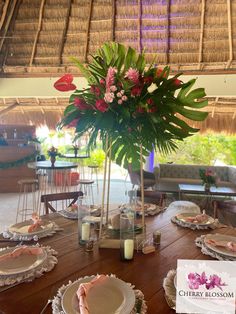 the table is set with plates and place settings