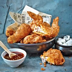 some fried food and dipping sauces on a table