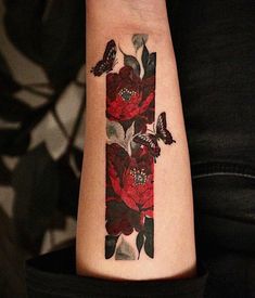 a woman's arm with flowers and butterflies on it