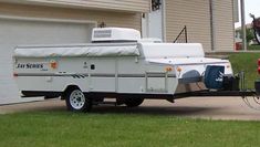 a camper trailer attached to a red fire hydrant