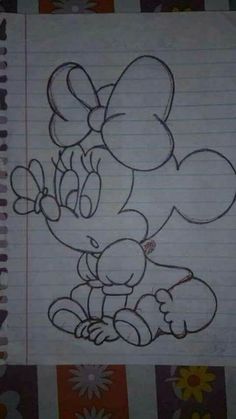 a drawing of mickey mouse on lined paper