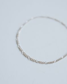 The slim, dainty figaro chain features high-quality sterling silver for a timeless, minimalist style that'll never go out of fashion. Invest in a life-long piece of jewelry you'll love forever! ∙ D E T A I L S ∙ - Dainty Figaro Chain- 925 Stamped Sterling Silver- Custom fit to your wrist ∙ STERLING ∙ SILVER ∙ Sterling silver is a metal alloy created by combining 92.5% pure silver with 7.5% other metals, typically copper. While Sterling Silver may darken due to oxygen exposure it can easily be polished without damaging the metal itself. You should even be able to pass your silver jewellery on to future generations! Figaro Bracelet, Figaro Chain, Figaro Chains, Love Forever, Silver Jewellery, Minimalist Style, Pure Silver, Go Out, Sterling Silver Bracelets