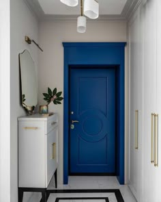 a blue door in a white room with black and white flooring