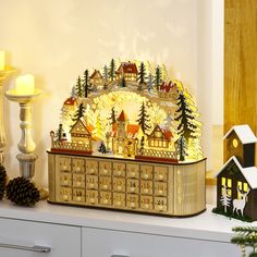 a lighted christmas scene with houses and trees