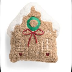 a gingerbread house ornament hanging on a wall