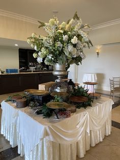 a table topped with lots of different types of food and flowers on top of it