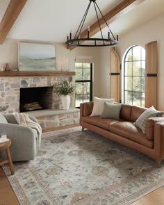 a living room filled with furniture and a fire place in the middle of an open floor plan