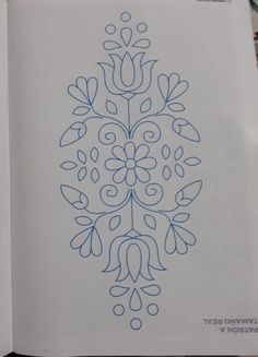 an open book with a drawing on it's cover and the title written in blue ink