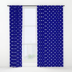 a blue curtain with white hearts on it and a window in the background that is open