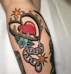 a tattoo on the arm of a person with an arrow and heart surrounded by stars