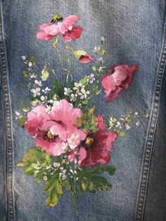 a painting of pink flowers on a jean jacket