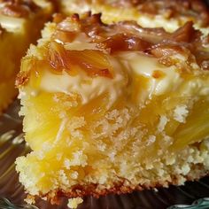 a close up of a piece of cake on a glass plate with another slice in the background