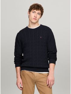 Tommy Hilfiger men's sweater. Made from soft cotton in a textured cable knit weave, this crewneck sweater is the perfect layer, complete with rib-knit cuffs, collar and hem with touches of subtle branding throughout.  Material: 100% Cotton. Tommy Hilfiger Sweater Men, Tommy Sweater, Tommy Hilfiger Sweater, Knit Crewneck, Tommy Hilfiger Man, Mens Crew Neck, High Point, Knit Cuff, Crewneck Sweater