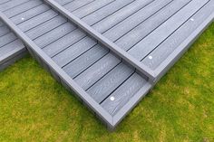 two wooden steps sitting on top of green grass