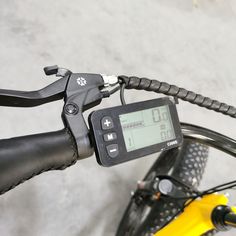 a close up of the handlebars on a bike with a speedometer attached to it