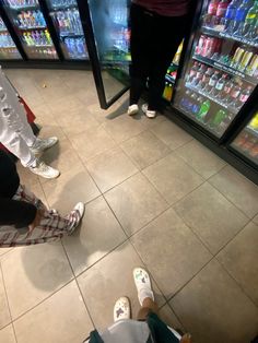 two people standing in front of a vending machine