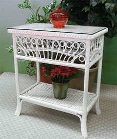 a white table with a potted plant on top