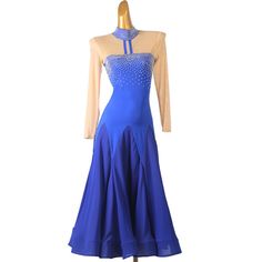 a woman's blue dress with beading on the neckline and long sleeves