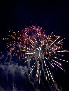 fireworks are lit up in the night sky