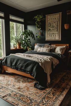 a bedroom with black walls and an area rug on the floor that has a bed in it