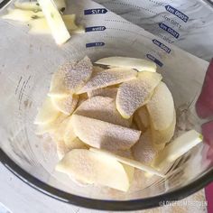 sliced apples are in a glass bowl on the counter top, ready to be blended