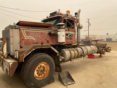 a large truck parked on top of a dirt field